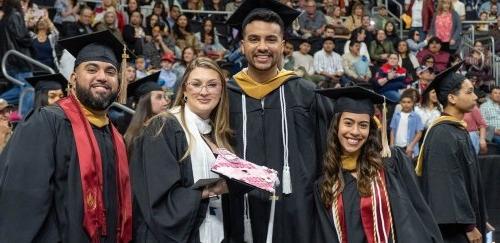 Proud graduates smiling and posing together in their caps and gowns